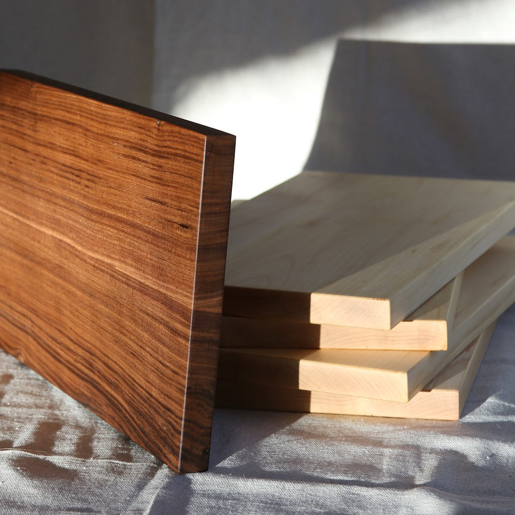 Stack of wooden boards on a textured surface