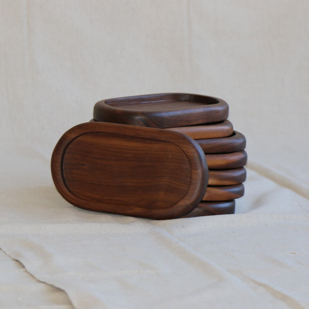 Stack of wooden trays on a light gray background