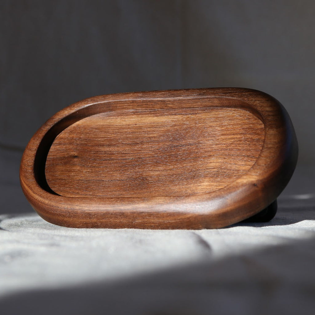Wooden tray on a light fabric background